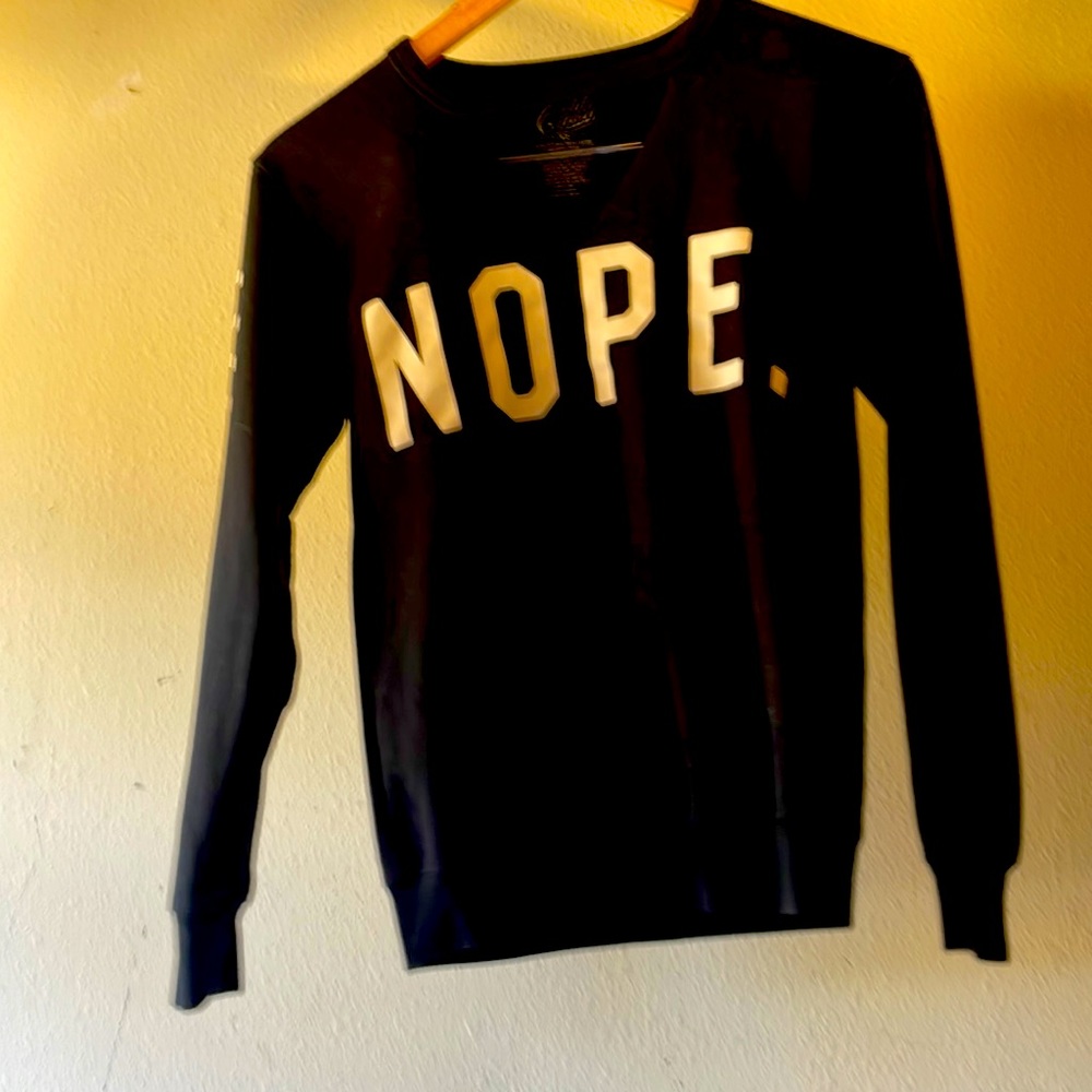 Black sweatshirt shirt that says nope on the front and not today on my he arm
